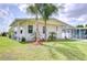 Charming home with well-maintained landscaping, a covered carport, and a welcoming facade at 5721 Apache St, Zephyrhills, FL 33542