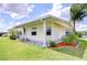 Exterior view of charming home featuring a covered porch and manicured landscaping at 5721 Apache St, Zephyrhills, FL 33542