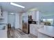 Well-lit kitchen featuring wood-look flooring and modern stainless steel refrigerator at 5721 Apache St, Zephyrhills, FL 33542