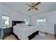 Comfortable main bedroom with a large bed, two side tables and two big windows at 5721 Apache St, Zephyrhills, FL 33542