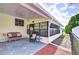 Relaxing outdoor patio area with comfortable seating and screened windows at 5721 Apache St, Zephyrhills, FL 33542