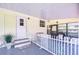 Covered porch with picket fence, offering an inviting outdoor seating area at 5721 Apache St, Zephyrhills, FL 33542