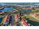Community aerial view featuring red-roofed condos, lakes, mature trees and ample parking at 6085 Bahia Del Mar Blvd # 106, St Petersburg, FL 33715