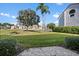 Scenic backyard view featuring lush grass, well-maintained landscaping, and a glimpse of a pond at 6085 Bahia Del Mar Blvd # 106, St Petersburg, FL 33715
