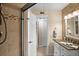 Bathroom featuring glass shower, stone tile and granite countertop at 6085 Bahia Del Mar Blvd # 106, St Petersburg, FL 33715