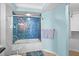 Stylish bathroom featuring blue mosaic tiles in glass shower, modern fixtures, and bright lighting at 6085 Bahia Del Mar Blvd # 106, St Petersburg, FL 33715