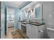 Bright bathroom featuring double sinks, granite countertops, and a decorative blue color scheme at 6085 Bahia Del Mar Blvd # 106, St Petersburg, FL 33715