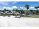 Inviting beach area with tiki huts and lounge chairs, offering a relaxing spot with views of the building at 6085 Bahia Del Mar Blvd # 106, St Petersburg, FL 33715