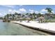 Serene beach with lounge chairs and umbrellas offering tranquil views of the water and the adjacent building at 6085 Bahia Del Mar Blvd # 106, St Petersburg, FL 33715