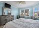 Bright bedroom featuring a large window, neutral decor, and comfortable furnishings at 6085 Bahia Del Mar Blvd # 106, St Petersburg, FL 33715