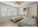 Bright bedroom features twin beds, built-in shelving, and a window with plantation shutters at 6085 Bahia Del Mar Blvd # 106, St Petersburg, FL 33715