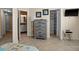 Bedroom showcasing a dresser, bathroom entrance, and closet with built-in shelving at 6085 Bahia Del Mar Blvd # 106, St Petersburg, FL 33715