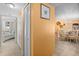 Hallway view with tile floors, coat closet, leading to a sunlit dining area and a glimpse of a bedroom at 6085 Bahia Del Mar Blvd # 106, St Petersburg, FL 33715