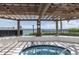 Relaxing hot tub under a wooden pergola with views of the surrounding area and clear blue skies at 6085 Bahia Del Mar Blvd # 106, St Petersburg, FL 33715