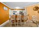 Kitchen with a breakfast bar, modern appliances, and a view of the adjacent dining area at 6085 Bahia Del Mar Blvd # 106, St Petersburg, FL 33715
