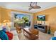 Inviting living room with tile flooring, ceiling fan, and sliding glass doors to the patio at 6085 Bahia Del Mar Blvd # 106, St Petersburg, FL 33715