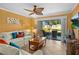 Bright living room with tile floors, a ceiling fan, and sliding glass doors opening to a patio at 6085 Bahia Del Mar Blvd # 106, St Petersburg, FL 33715