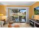 Cozy patio setting with seating, sliding glass door access, and serene views of landscaped grounds at 6085 Bahia Del Mar Blvd # 106, St Petersburg, FL 33715