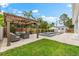 Backyard featuring an outdoor seating area, a sparkling pool, hot tub, and lush landscaping at 6121 33Rd N Ave, St Petersburg, FL 33710