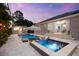 A sparkling pool and spa is the centerpiece of this outdoor oasis including a cabana and covered seating at 6121 33Rd N Ave, St Petersburg, FL 33710