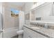 Bathroom features a granite countertop and a shower-tub combo that offers a functional and elegant space at 6121 33Rd N Ave, St Petersburg, FL 33710