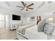 Bedroom featuring wood-look tile, a large television, walk-in closet, and an ensuite bathroom at 6121 33Rd N Ave, St Petersburg, FL 33710