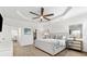 Light, bright bedroom with wood look tile floors, tray ceiling, and ensuite bathroom and closet at 6121 33Rd N Ave, St Petersburg, FL 33710