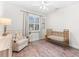 Bedroom featuring a decorative rug, brass crib, and a large window for ample natural light at 6121 33Rd N Ave, St Petersburg, FL 33710