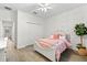 Charming bedroom features a cozy bed, closet, decorative wall and a faux tree for natural light at 6121 33Rd N Ave, St Petersburg, FL 33710
