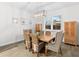 Bright dining room featuring wood-look floors, a contemporary light fixture, and shutters on the window at 6121 33Rd N Ave, St Petersburg, FL 33710