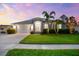 Well-kept home with a green lawn, palm trees, and a two-car garage, creating a pleasant curb appeal at 6121 33Rd N Ave, St Petersburg, FL 33710