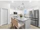 Modern kitchen with granite countertops, stainless steel appliances, an island with seating and pendant lighting at 6121 33Rd N Ave, St Petersburg, FL 33710