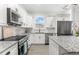 Updated kitchen with granite countertops, stainless appliances and a kitchen island for extra counter space at 6121 33Rd N Ave, St Petersburg, FL 33710