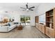 Bright living room with tile floors, vaulted ceilings, a modern ceiling fan, and sliding glass doors to the pool at 6121 33Rd N Ave, St Petersburg, FL 33710