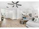 Bright and airy living room featuring wood-look tile floors, ceiling fan, and comfortable gray sectional sofa at 6121 33Rd N Ave, St Petersburg, FL 33710