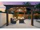 Inviting covered outdoor lounge with comfortable seating, a fire pit, ceiling fan, and TV overlooking the yard at 6121 33Rd N Ave, St Petersburg, FL 33710