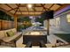 Inviting covered outdoor lounge with comfortable seating, a fire pit, ceiling fan, and TV, perfect for relaxing evenings at 6121 33Rd N Ave, St Petersburg, FL 33710
