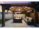 Inviting covered outdoor lounge with comfortable seating, a fire pit, ceiling fan, and TV for relaxing outside at 6121 33Rd N Ave, St Petersburg, FL 33710