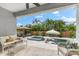 Outdoor patio with a pool, spa, lounge chairs, and comfortable seating for relaxation and entertainment at 6121 33Rd N Ave, St Petersburg, FL 33710