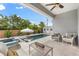 Outdoor patio with a pool, spa, lounge chairs, and comfortable seating for relaxation and entertainment at 6121 33Rd N Ave, St Petersburg, FL 33710