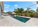 Backyard pool with a spa, lounge chairs, and a wooden fence for privacy and relaxation at 6121 33Rd N Ave, St Petersburg, FL 33710