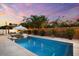 A beautiful in-ground pool is surrounded by lush tropical landscaping and a privacy fence at 6121 33Rd N Ave, St Petersburg, FL 33710