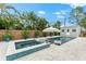 Backyard features a sparkling pool, hot tub, shed, lounge chairs, and lush landscaping at 6121 33Rd N Ave, St Petersburg, FL 33710