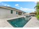 Stunning backyard oasis with a sparkling pool, luxurious lounge chairs, and an inviting outdoor seating area at 6121 33Rd N Ave, St Petersburg, FL 33710
