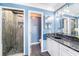 This contemporary bathroom features a walk-in glass shower, granite counters, and modern fixtures at 6121 Fjord Way, New Port Richey, FL 34652