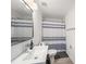 Clean bathroom featuring a vanity sink and a shower with a striped curtain at 6121 Fjord Way, New Port Richey, FL 34652