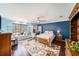 Inviting bedroom with natural light, hardwood floors, and blue accent wall at 6121 Fjord Way, New Port Richey, FL 34652