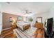 Cozy bedroom with warm colors, hardwood flooring, and a large window at 6121 Fjord Way, New Port Richey, FL 34652