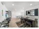 Dining area and kitchenette featuring modern plank flooring, wainscoting, and decorative lighting at 6121 Fjord Way, New Port Richey, FL 34652