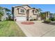 Lovely home featuring a circular brick driveway design and tropical landscaping at 6121 Fjord Way, New Port Richey, FL 34652